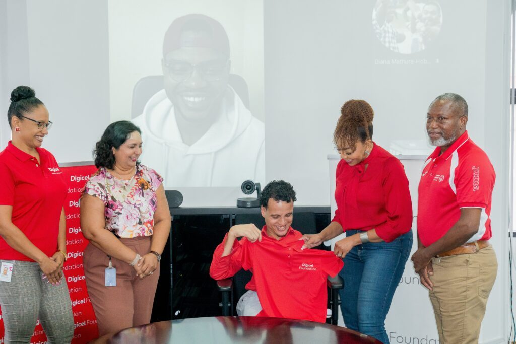 Digicel Foundation CEO Penny Gomez, second from right, presents Digicel Foundation endorsee and 94.1 FM's DJ Joe Brien with a shirt at the launch of the 2024 Special Olympics TT National Games on May 1. - Photo courtesy Digicel Foundation (Image obtained at newsday.co.tt)